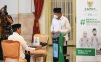 Presiden Jokowi Mencoba Fasilitas Robot Zakat di Istana Negara